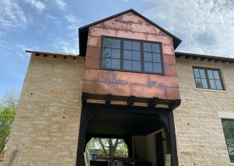 Copper metal panel facade on a stone building for Skylight Installation in Grant-Valkaria